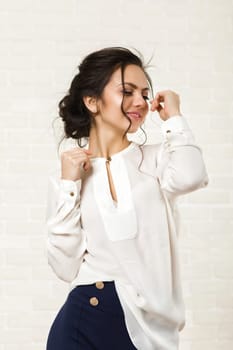beautiful happy brunette woman in a white blouse