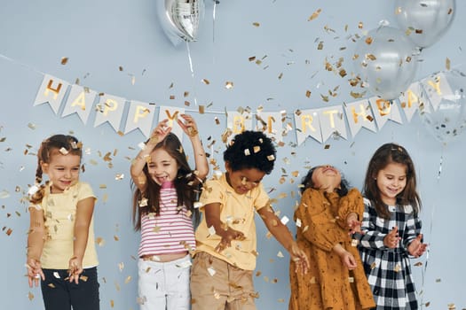 Children on celebrating birthday party indoors have fun together