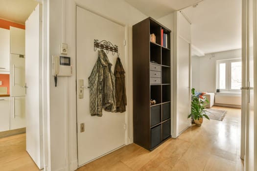 a hallway with a wardrobe and a door open to