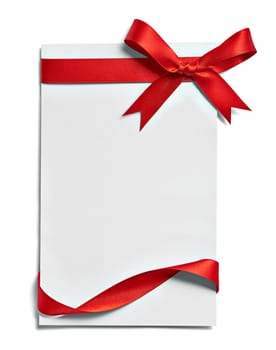 close up of a note card with red ribbon bow on white background