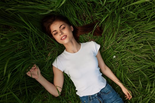 woman dreaming lying on the grass