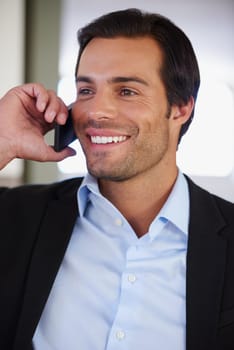 Glad I could be of assistance. a handsome businessman smiling while talking on the phone.