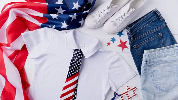 USA Memorial day, Presidents day, Veterans day, Labor day, or 4th of July celebration. Mockup design white polo t shirt for logo, top view on white wooden background with US flag, shoes and jeans