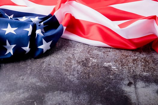 Closeup of American flag on dark cement background