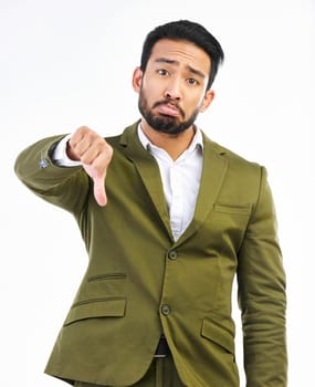 Thumbs down, sad man and portrait in a studio with bad feedback, voting and emoji hand sign. Negative opinion, decision and wrong hands gesture of a upset business man with isolated white background