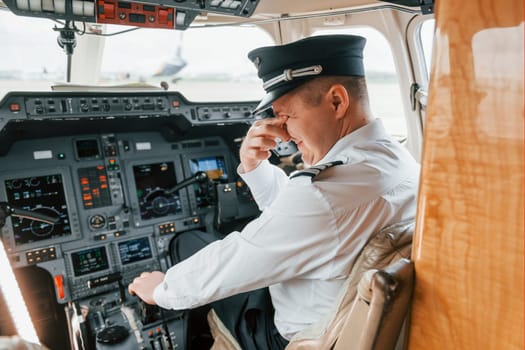 Pilot on the work in the passenger airplane. Preparing for takeoff