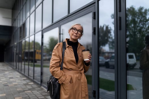 elderly woman director enters the business center, woman leader in business concept