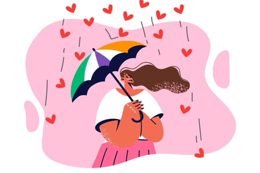Positive woman tries umbrella to hide from falling hearts symbolizing excessive love and care