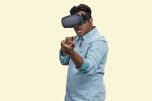 Brown man in vr headset shooting from invisible weapon.
