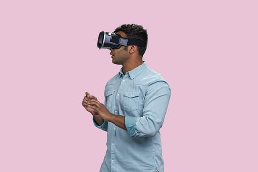Young brown southasian man in vr headset.