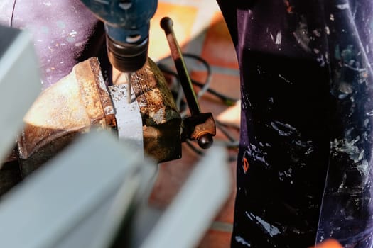 Metalworker working on a drilling machine