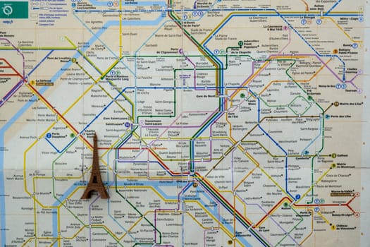 Close up of Paris metro subway map with a toy Eiffel tower on top