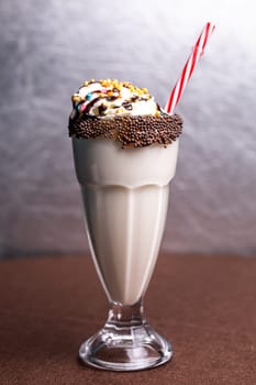 milkshake with multicolored sprinkles and a straw