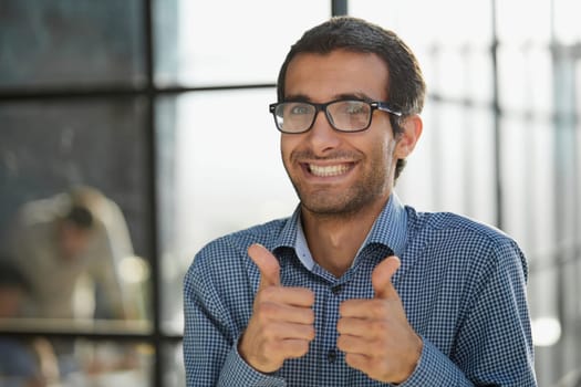 Young businessman in casual wear approves positive hand gesture