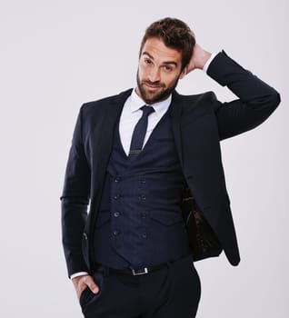 Handsome and successful. Studio shot of a well-dressed man against a gray background.
