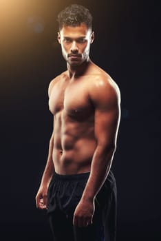Strong is not just physical strength, its a mindset. Studio shot of a fit young man isolated on black.