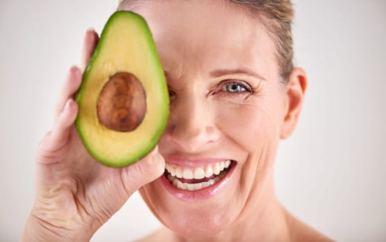 Have you tried an avo mask. Cropped studio portrait of a mature woman holding up an avocado.
