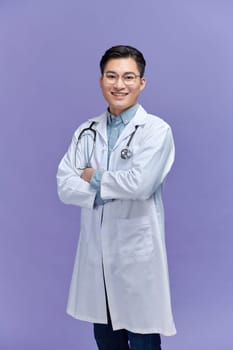portrait of friendly Asian doctor man over purple smiling to camera
