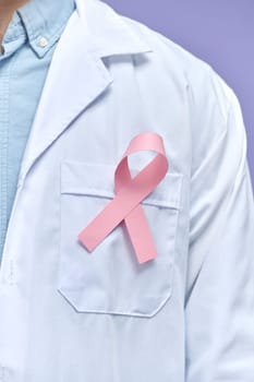 Doctor wearing lab coat wearing breast cancer awareness ribbon