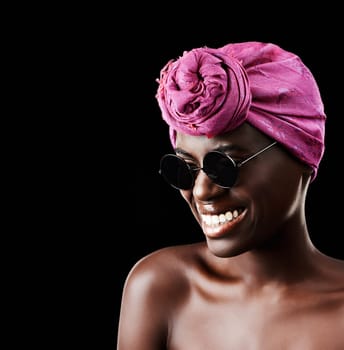 My style, my way. Studio shot of a beautiful woman wearing a headscarf against a black background.