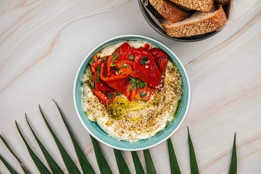 Portion of hummus bowl with baked pepper