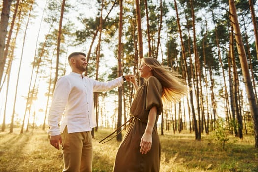 Closeness of the people. Happy couple is outdoors in the forest at daytime