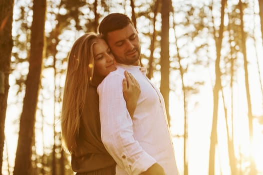 Tenderness and hapiness. Couple is outdoors in the forest at daytime