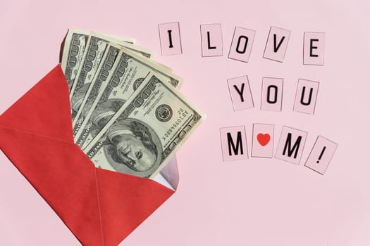 Money in red envelopes. Happy mothers day greeting gift, closed up of pile of US dollar banknotes.Banknotes folded in an envelope as a present. Sending or saving money, corruption concept