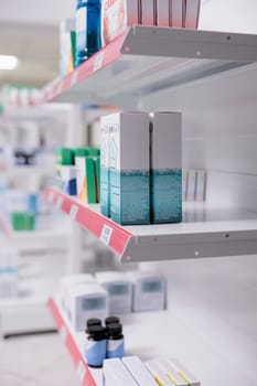 Selective focus of drugstore shelves filled with vitamins and pharmaceutical products to sell prescription medicine