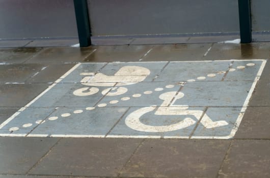 A place allocated for parking for disabled people and strollers with children at a public transport stop.