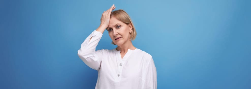 blond middle aged woman with headache and premenstrual syndrome