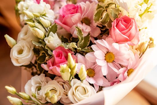 Modern floral bouquet of different flowers, colorful bunch of flowers.pink roses, Chrysanthemum. daisy and Eustoma. Colorful postcard. Congratulation or present concept.