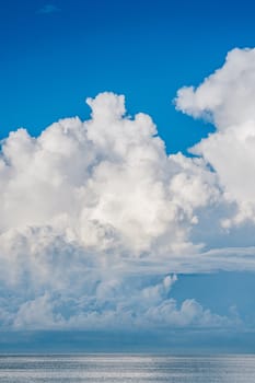 A large white cloud is above a blue sky.
