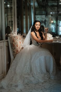 portrait of a bride in a white dress in a bright cafe