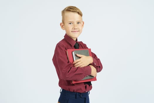 Pupil holding books in hands, isolated background.