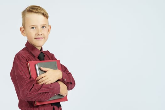 Pupil holding books in hands, isolated background.