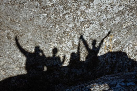 Shadow of a group of people on a rock