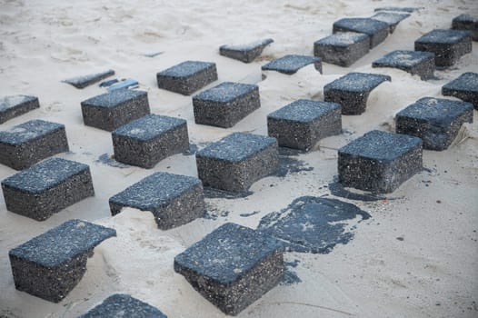 square granite blocks on the beach to reinforce the coast