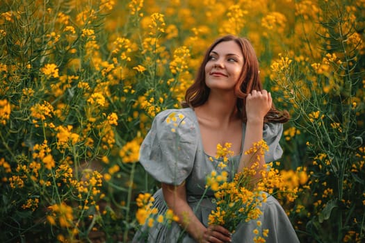 Happy woman in blooming canola flowers field. Lady in retro dress, spring season