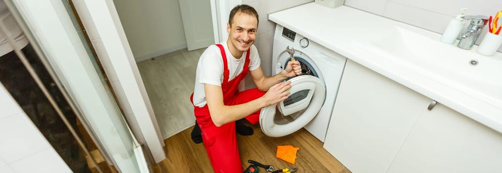 Plumber repairing washing machine fix