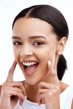 Happy, gesture and portrait of a woman for beauty isolated on a white background in a studio. Smile, skincare and face of a young model looking confident about clear complexion and smooth skin