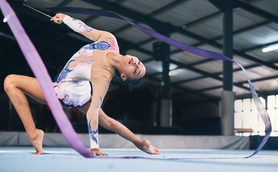 Ribbon, gymnastics and flexible woman stretching in performance, dance training and sports competition. Female, rhythmic movement and dancing athlete for creative skill, talent and concert in arena