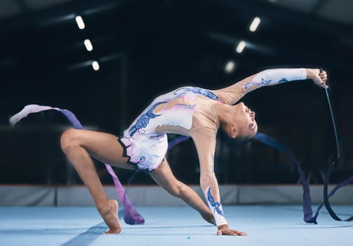 Ribbon, gymnastics and flexible woman stretching in performance, dance training and sports competition. Female, rhythmic movement and dancing athlete, creative skill and talent for concert in arena
