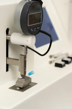 A vertical closeup shot of equipment in a medical laboratory for manufacturing medical syringes