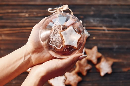 Woman holding sphere object. Christmas background with holiday decoration