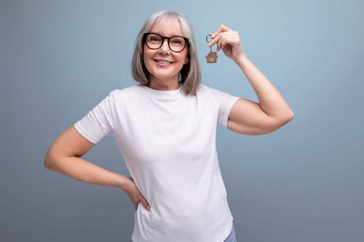 retirement business. mature woman holding real estate keys
