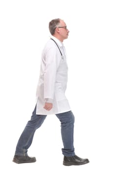 Middle age male doctor walking away and look at camera isolated on white