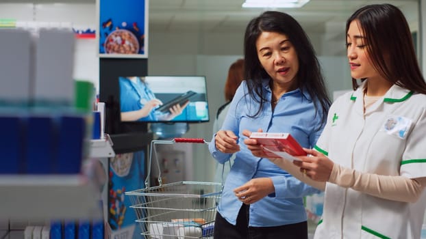 Asian customer showing prescription paper to employee
