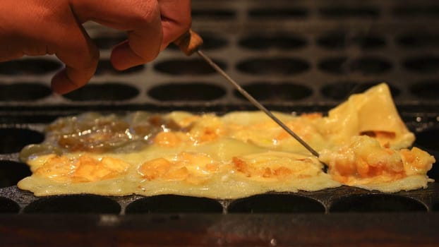 The cooking of Takoyaki. The popular Japanese street food.