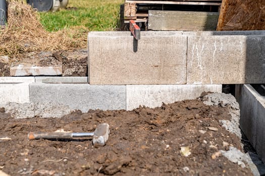the foundation of the house is made of concrete blocks bound with metal armature